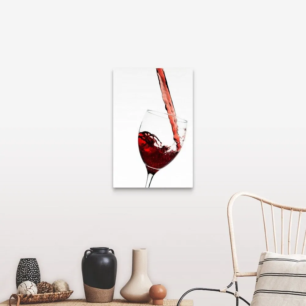 "Close up of red wine being poured into glass on white background" Canvas Wall Art