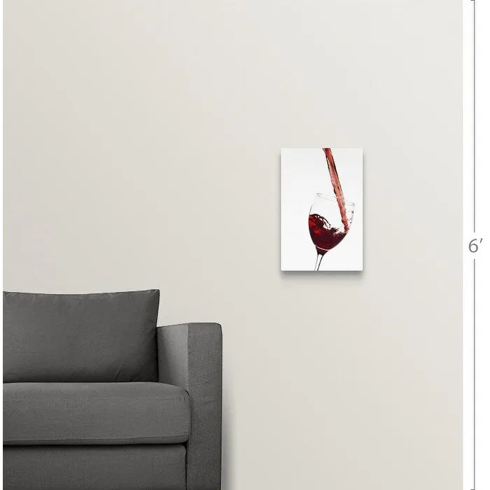 "Close up of red wine being poured into glass on white background" Canvas Wall Art