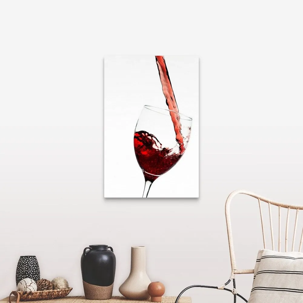 "Close up of red wine being poured into glass on white background" Canvas Wall Art